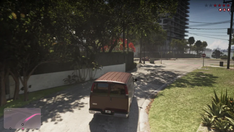 Maroon enclosed van with two rear doors turning on a city street