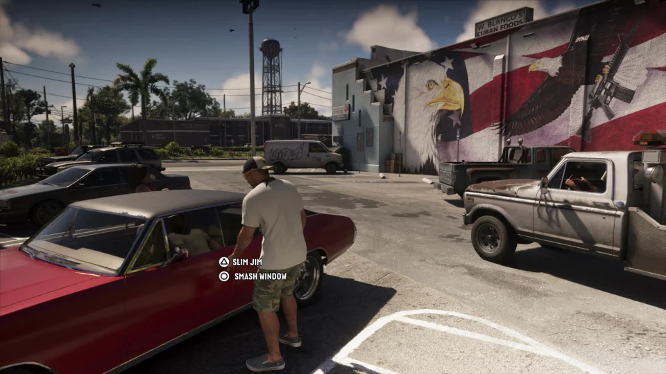 Parking lot with a red classic car, tow truck and old pickup in the background