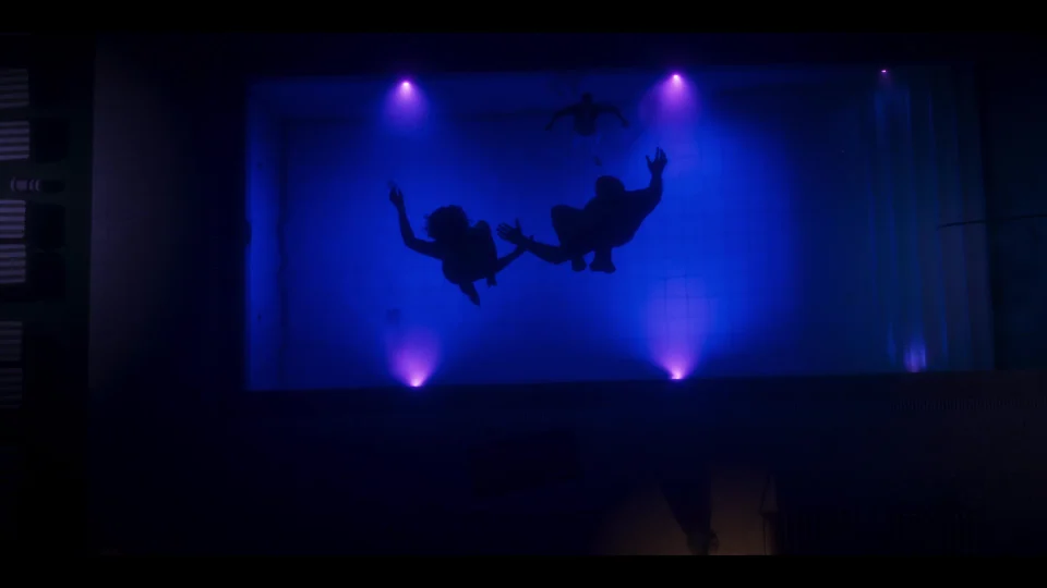 Blue and purple lights beside the pool at night