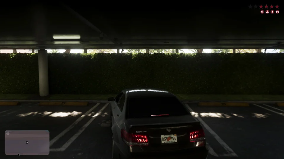 Black sedan seen from behind under a canopy after a chase